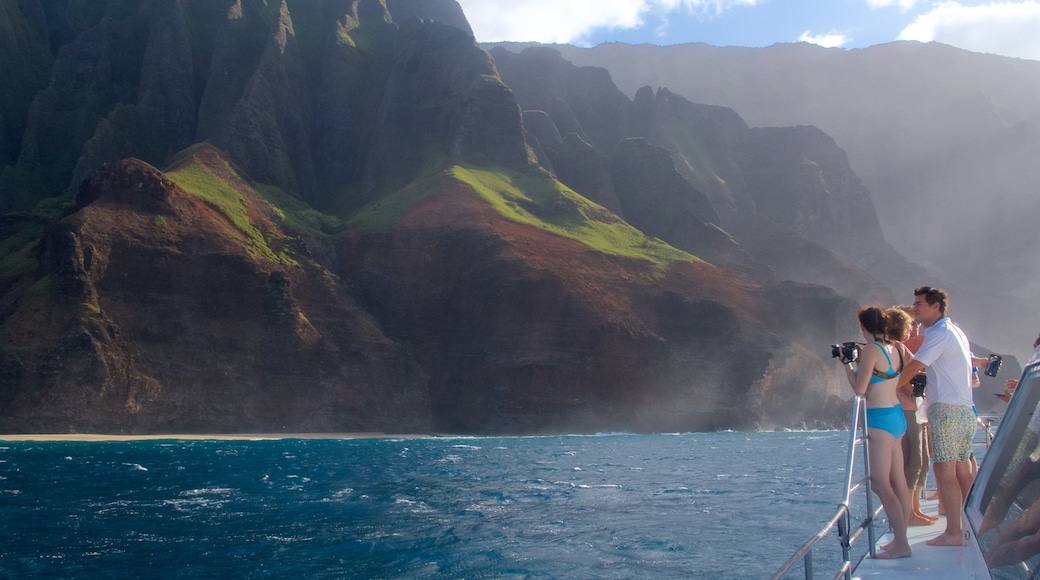 Hanalei which includes a gorge or canyon and general coastal views as well as a small group of people