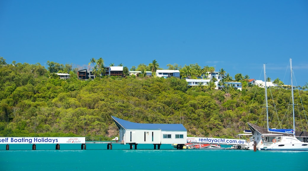 Shute Harbour which includes tropical scenes, signage and general coastal views