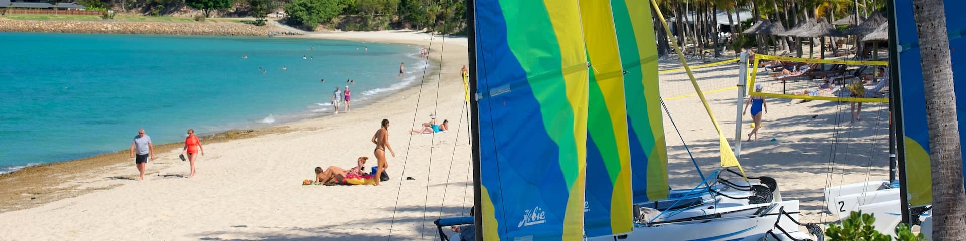 Catseye Beach showing a beach and sailing as well as a small group of people
