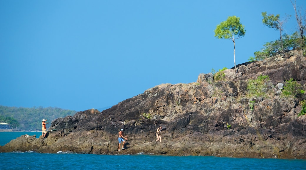 Conway National Park featuring rocky coastline as well as a small group of people