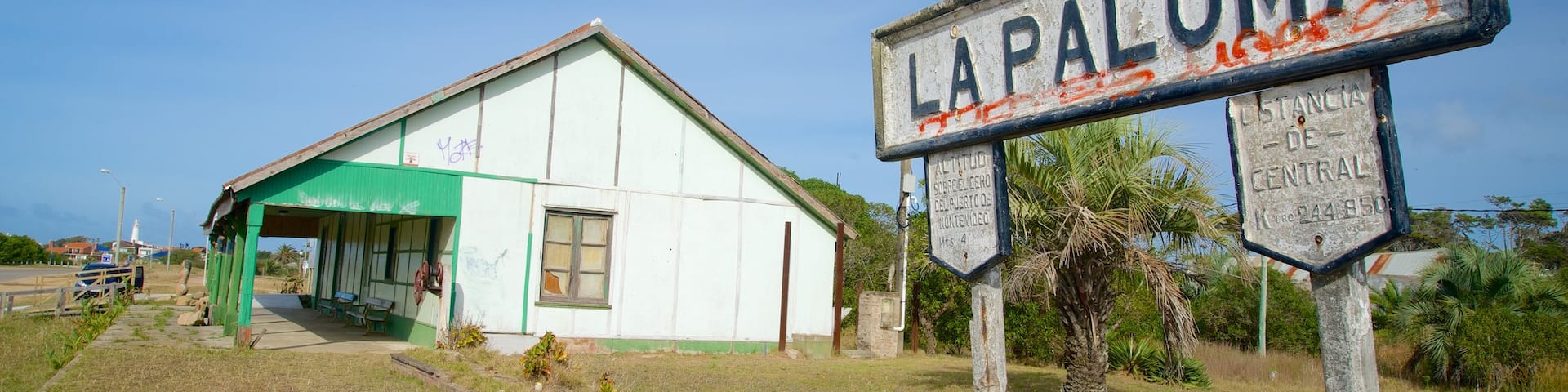 Old Train Station featuring signage and a small town or village