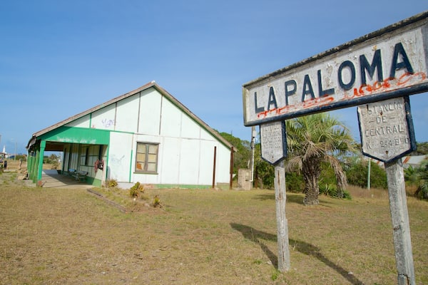 Old Train Station featuring a small town or village and signage