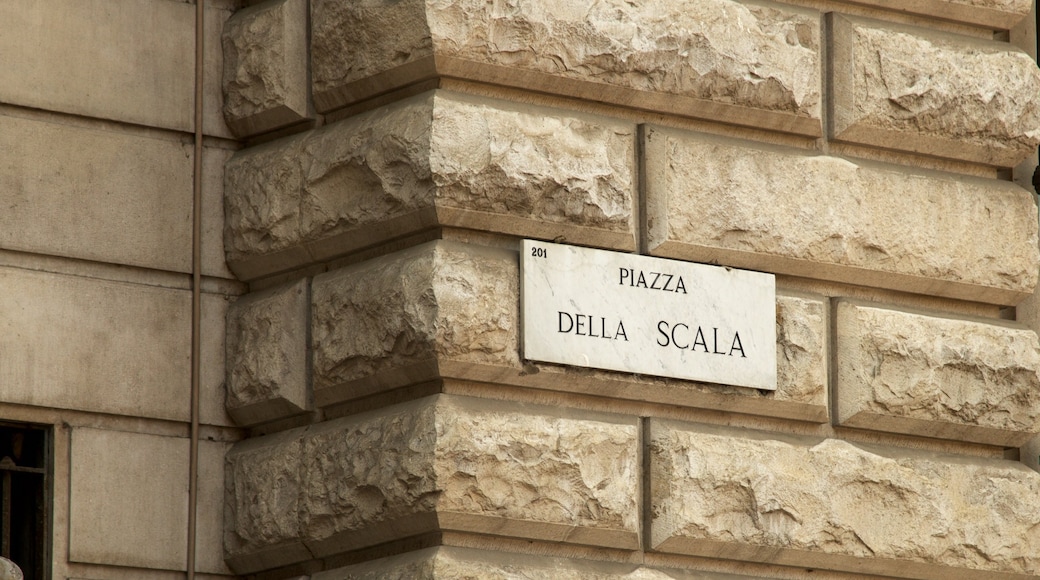 Piazza della Scala which includes signage, a castle and heritage architecture