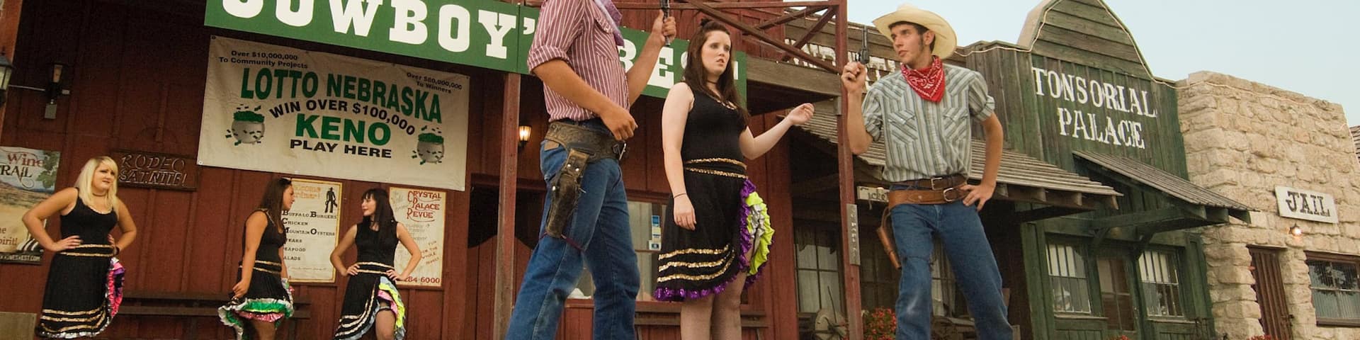 Ogallala showing performance art, signage and a small town or village