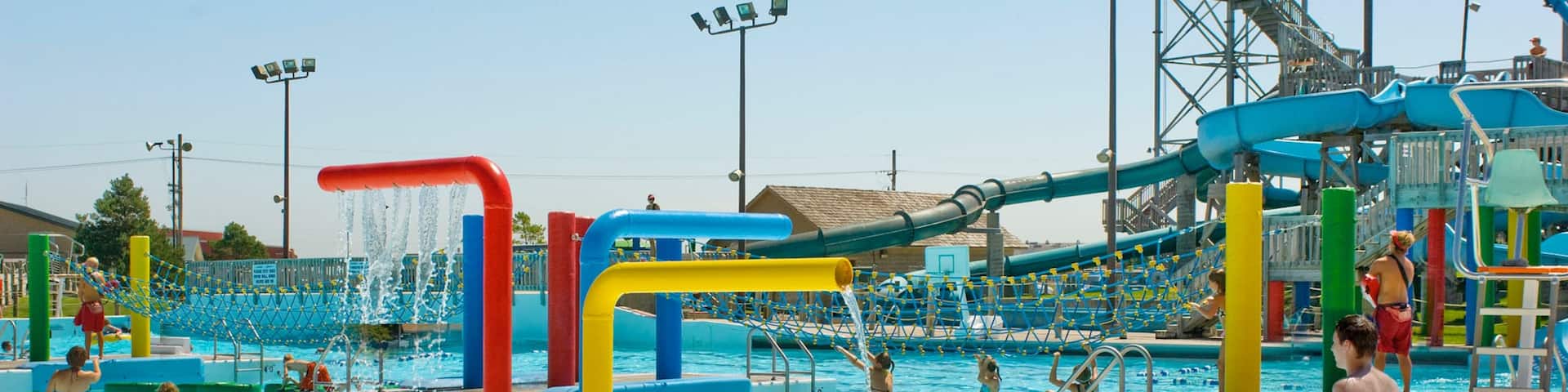 Island Oasis Water Park which includes a waterpark and swimming as well as a small group of people