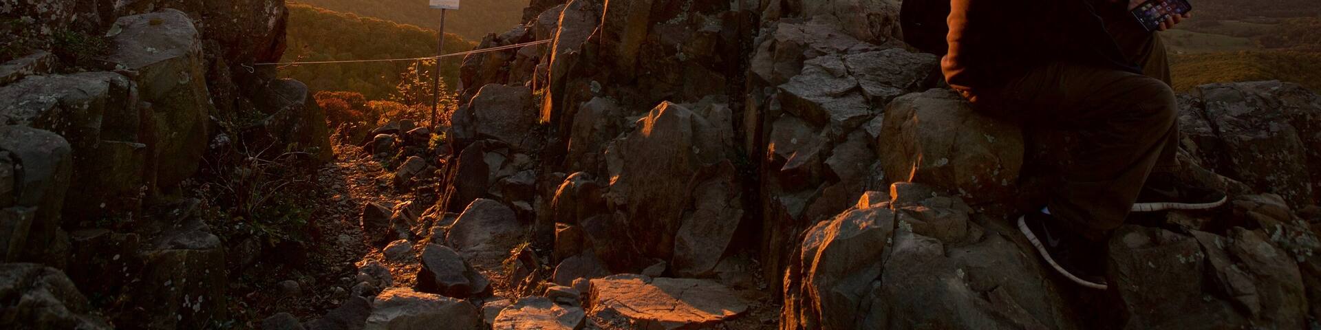 Shenandoah National Park featuring mountains and a sunset as well as a couple