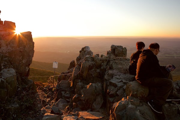 Shenandoah National Park which includes mountains and a sunset as well as a couple