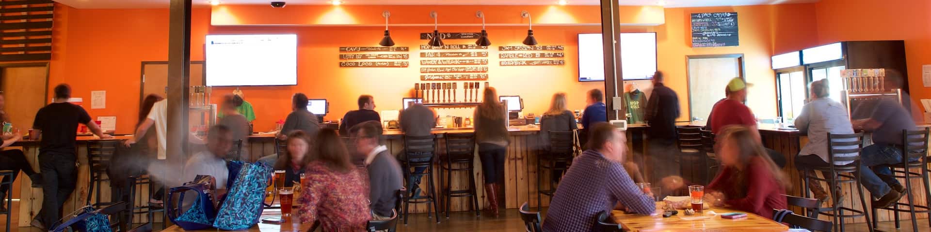 NoDa Brewing Company which includes interior views and a bar as well as a small group of people