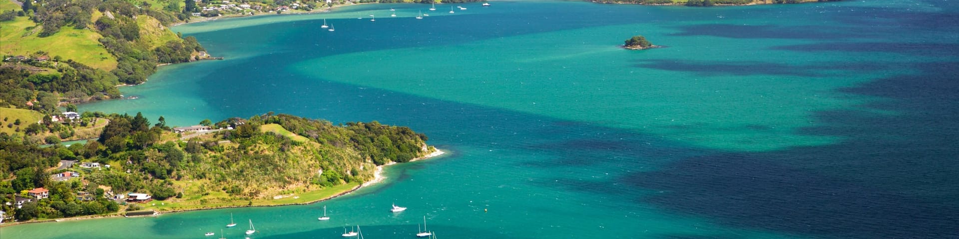 Mount Manaia which includes a bay or harbor, a coastal town and mountains