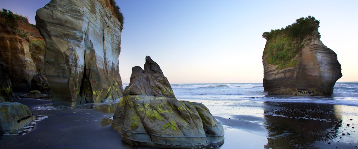 Tongaporutu featuring rocky coastline, a beach and a bay or harbor