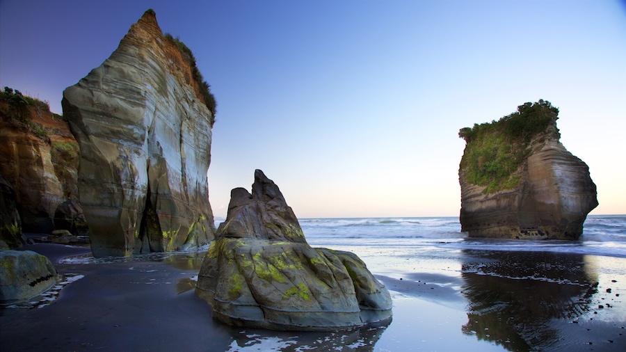 Tongaporutu which includes a sunset, rocky coastline and a sandy beach