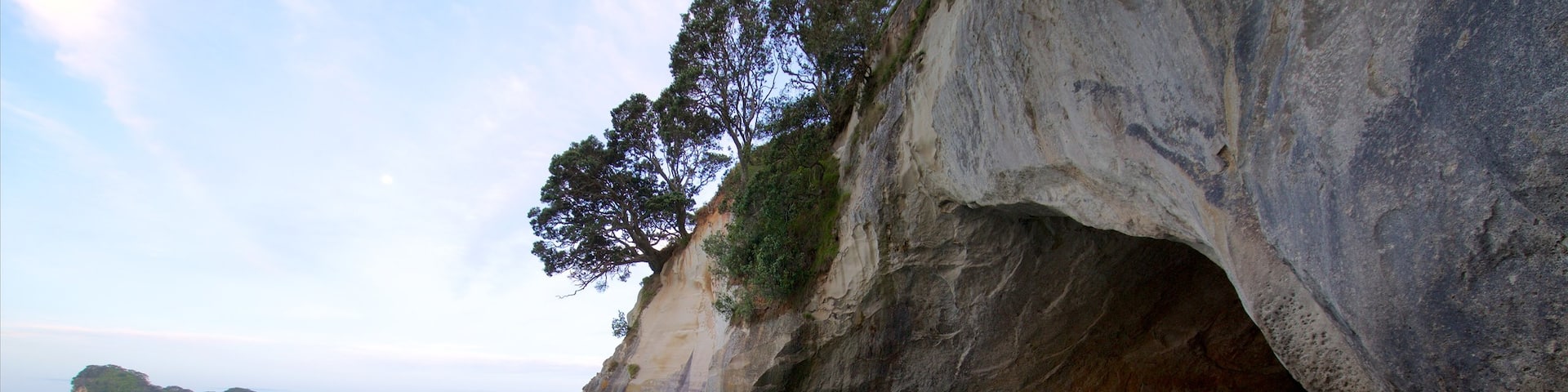 Coromandel Peninsula featuring a bay or harbour, rugged coastline and a sunset