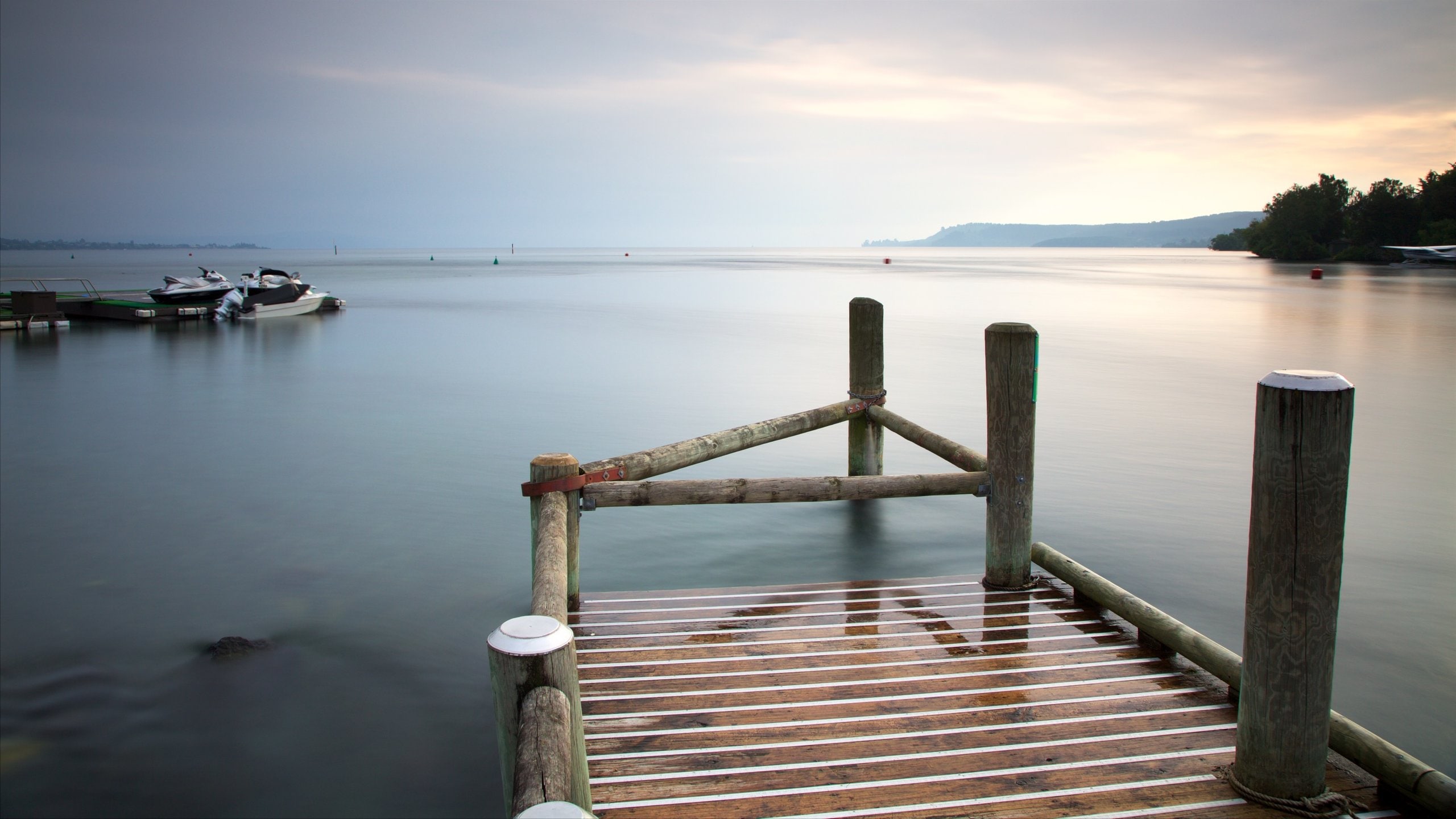 Lake Taupo which includes a lake or waterhole, boating and a sunset