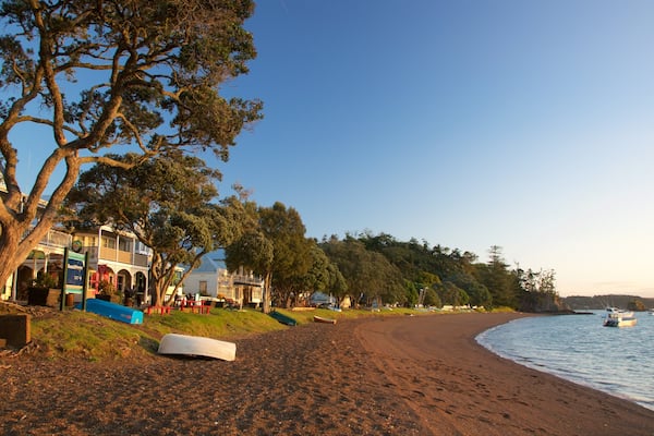 Russell Beach featuring a bay or harbour, a sandy beach and a coastal town