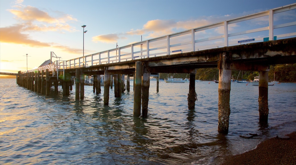 Russell Beach which includes a sunset and a bay or harbour