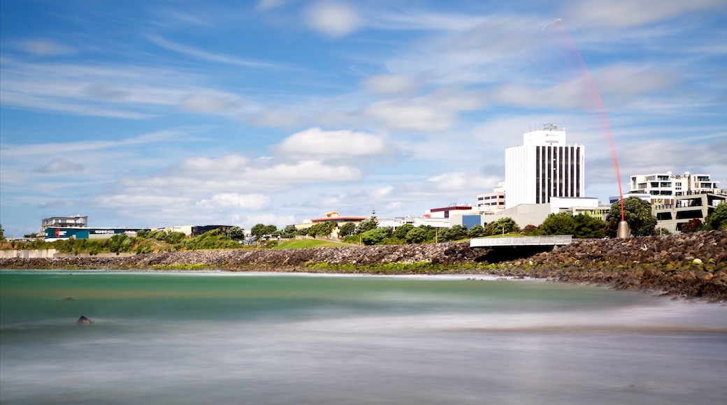 Taranaki showing a bay or harbour and rugged coastline