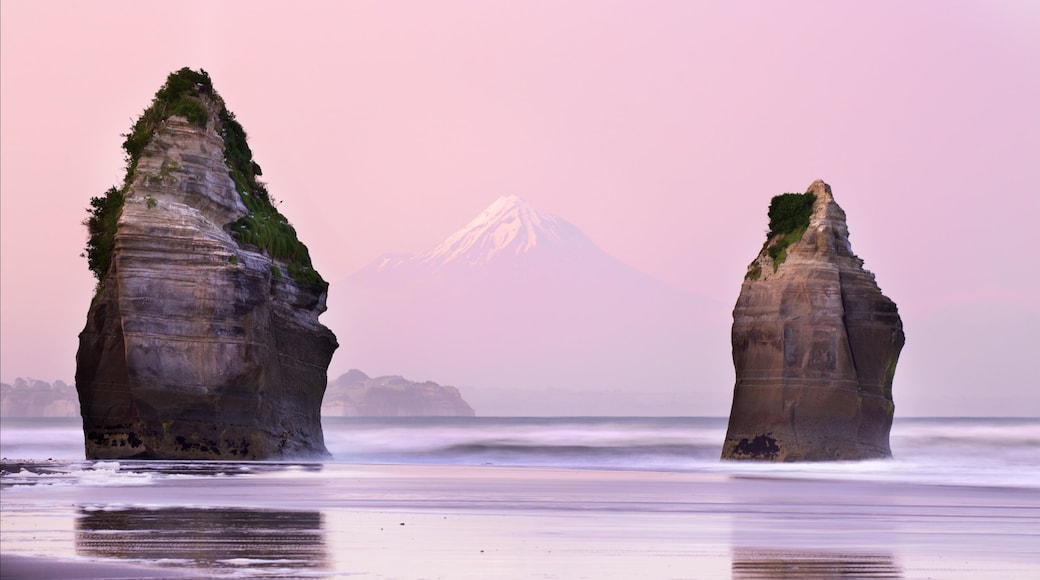 Tongaporutu showing mountains, a sunset and rugged coastline