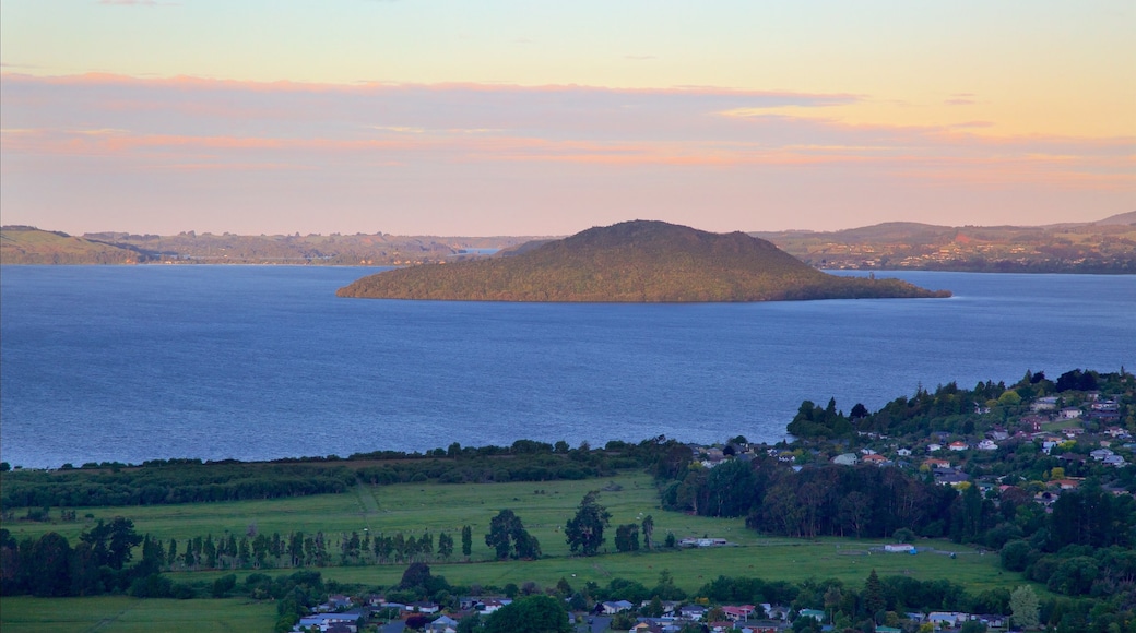 Mokoia Island which includes a lake or waterhole, a sunset and a small town or village