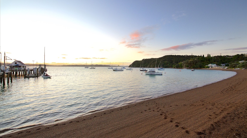 Russell Beach which includes a bay or harbour, a sunset and a pebble beach