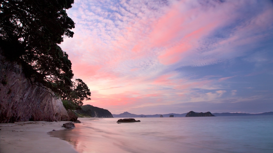 Hahei Beach showing a beach, a bay or harbour and a sunset