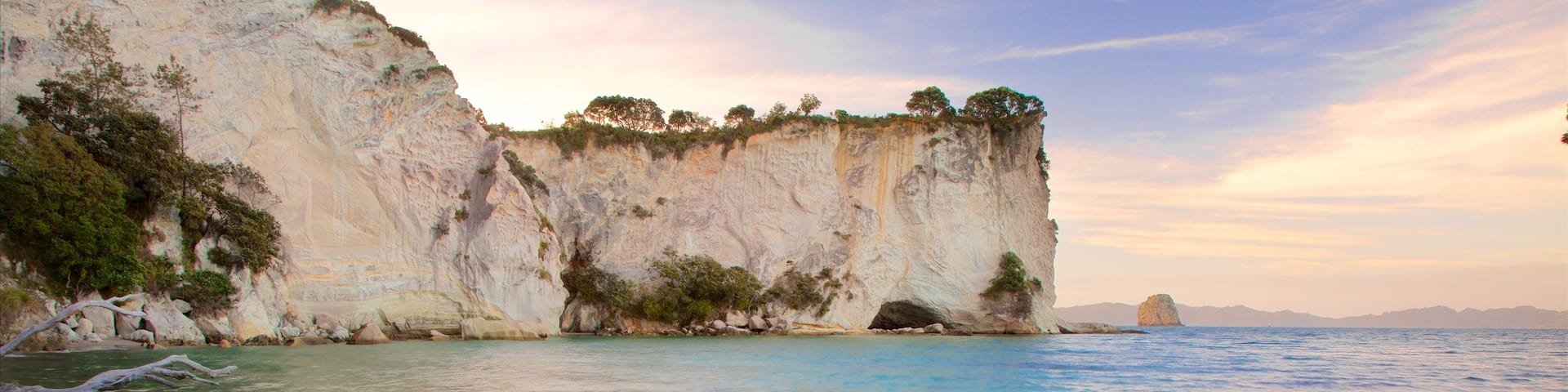 Whitianga showing a bay or harbor, a sunset and rocky coastline