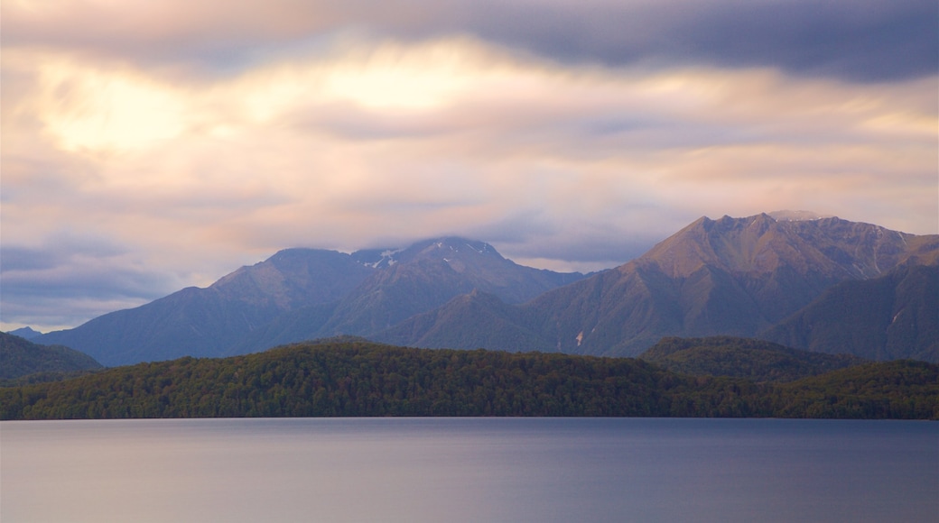 Lake Te Anau which includes mountains, a lake or waterhole and a sunset