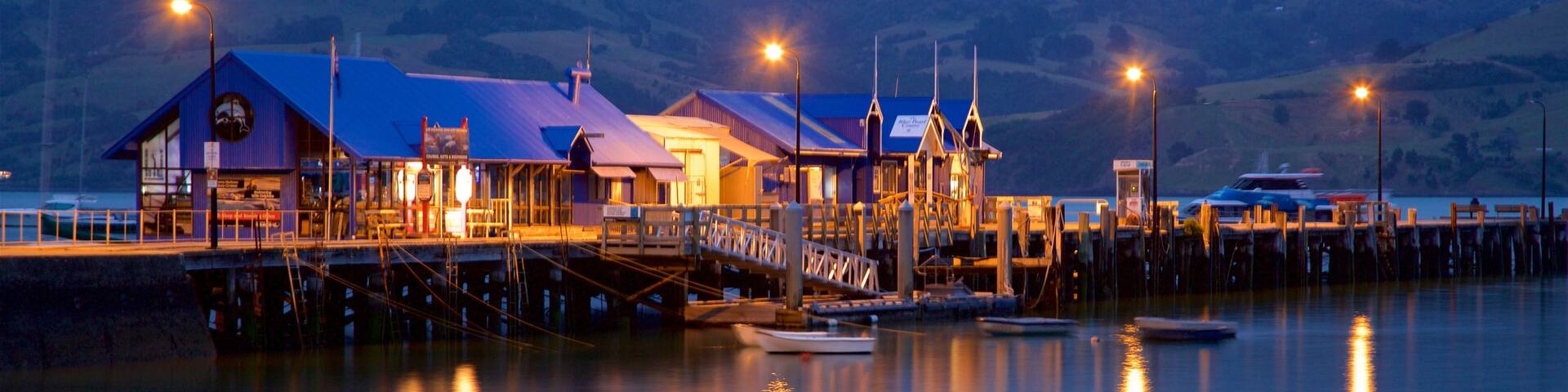 Akaroa Wharf featuring a bay or harbour, night scenes and a marina