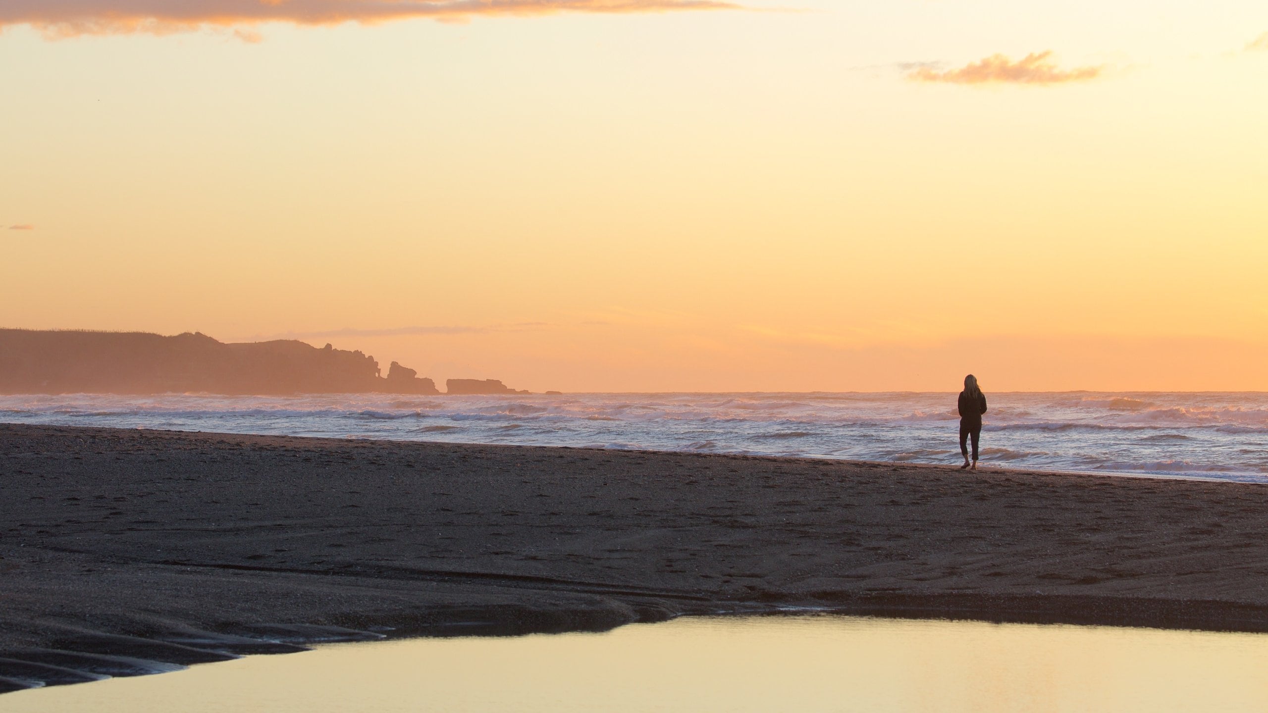 Greymouth showing rocky coastline, a sunset and a sandy beach