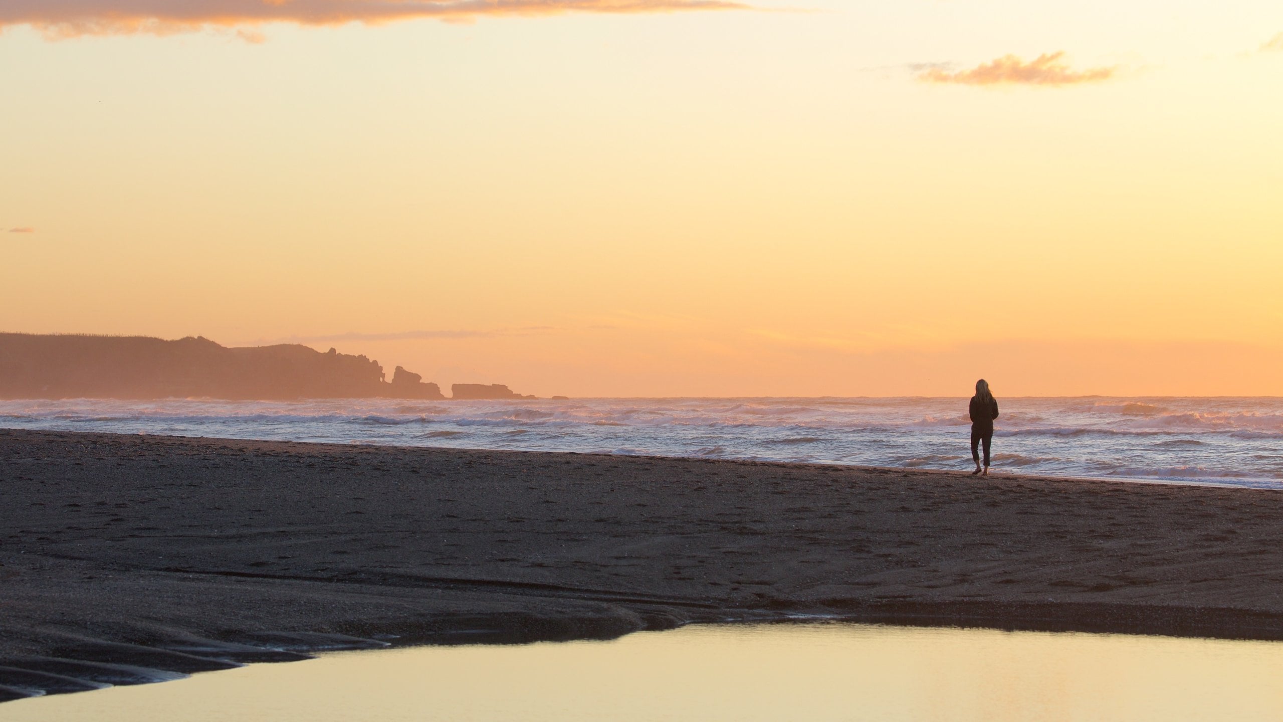 Greymouth featuring a sandy beach, a sunset and surf