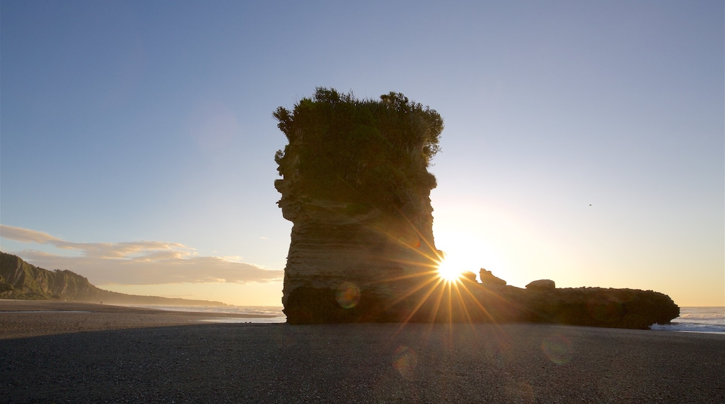 Punakaiki featuring a sunset, rugged coastline and a beach