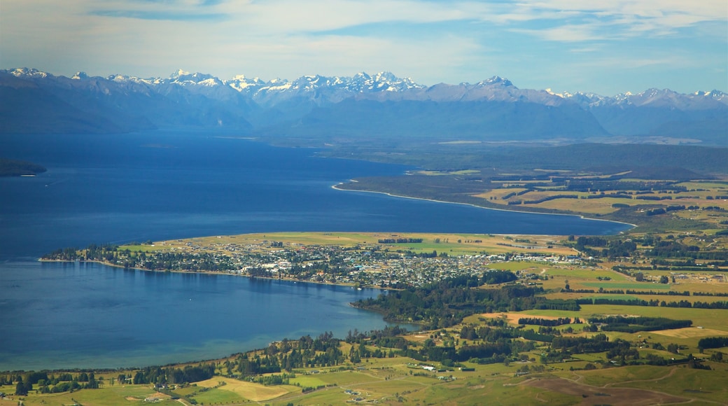 Lake Te Anau which includes a lake or waterhole, mountains and a coastal town