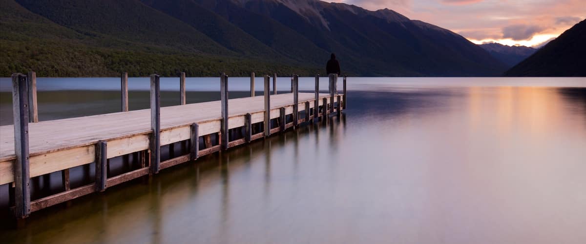 Nelson Lakes National Park which includes mountains, a sunset and a bay or harbor