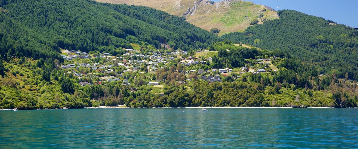 Sunshine Bay featuring forests, mountains and a small town or village