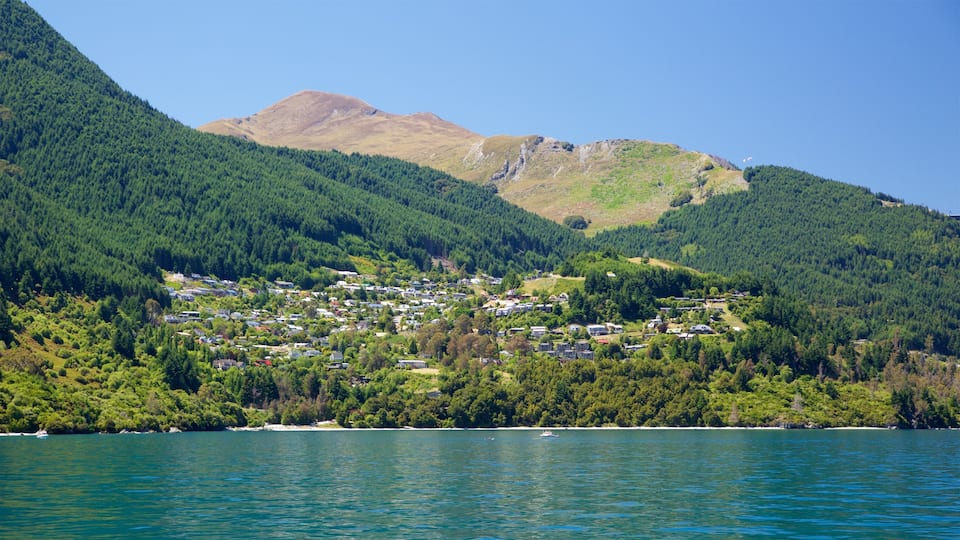 Sunshine Bay featuring forests, mountains and a small town or village
