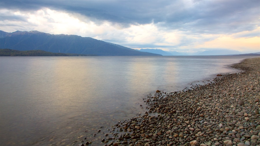 Lake Te Anau featuring mountains, a sunset and a lake or waterhole
