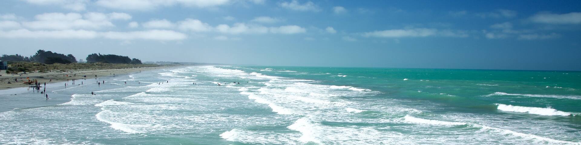 New Brighton Beach showing surf, a beach and surfing