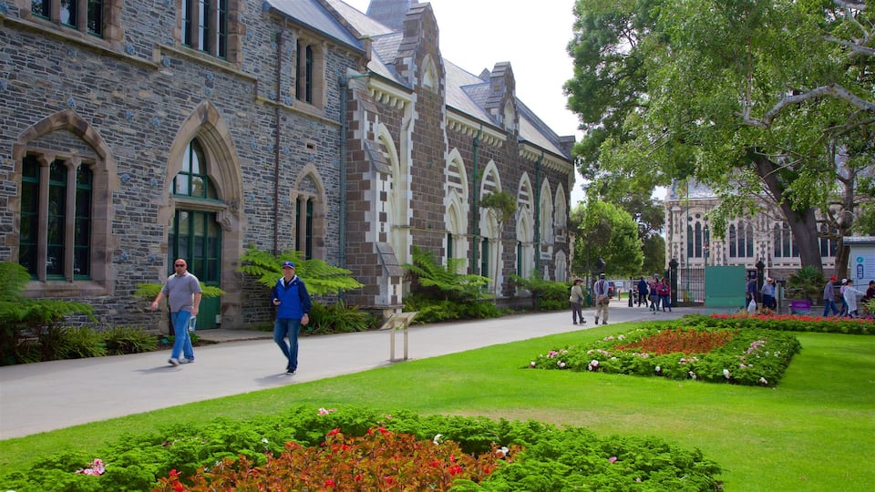 Canterbury Museum showing heritage architecture and a garden as well as a small group of people