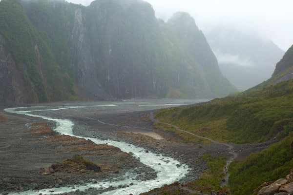 Fox Glacier featuring a river or creek, mountains and mist or fog