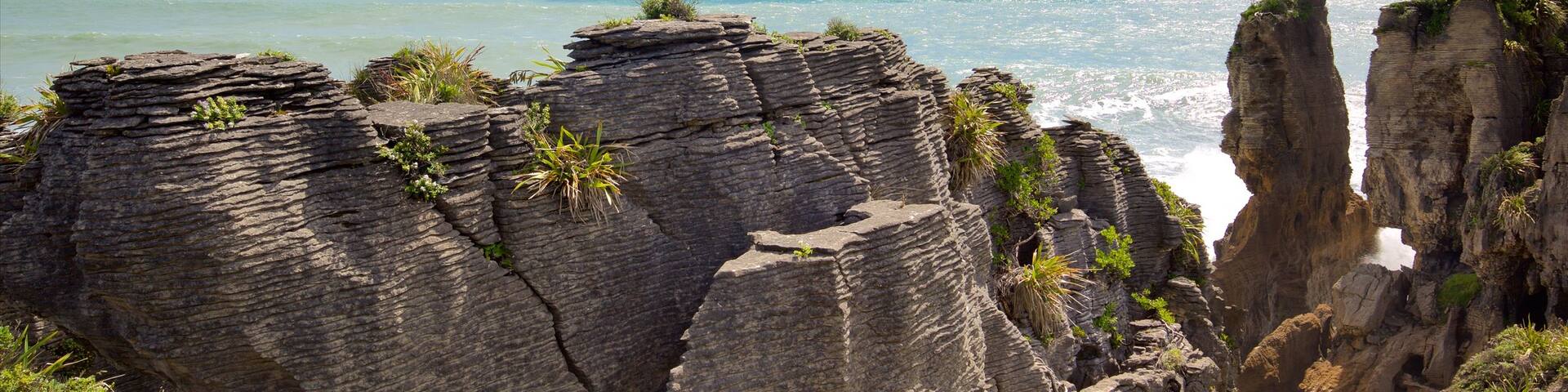 Pancake Rocks featuring a bay or harbour and rocky coastline
