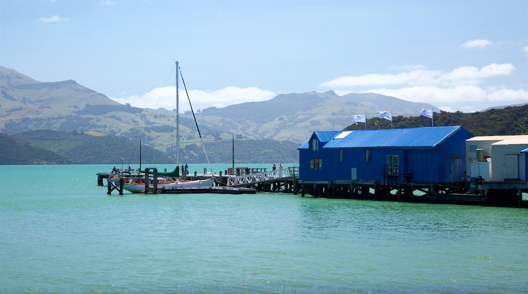 Akaroa Wharf which includes sailing, mountains and a bay or harbor