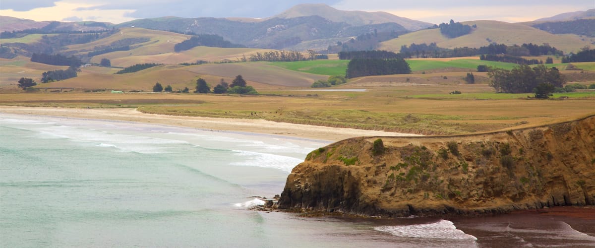 Moeraki Lighthouse which includes a beach, tranquil scenes and a bay or harbour