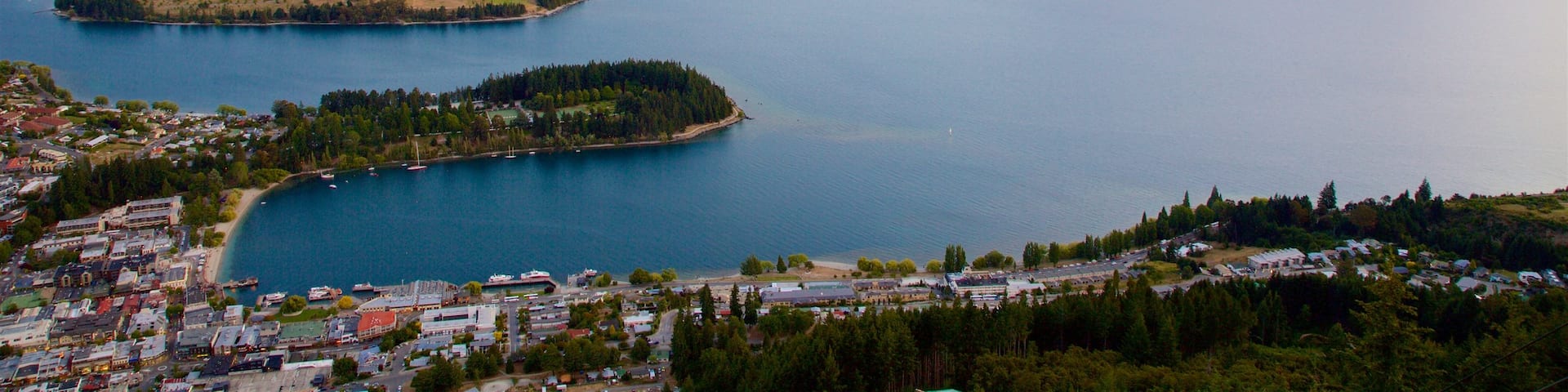 Cecil Peak which includes a small town or village, a lake or waterhole and a sunset