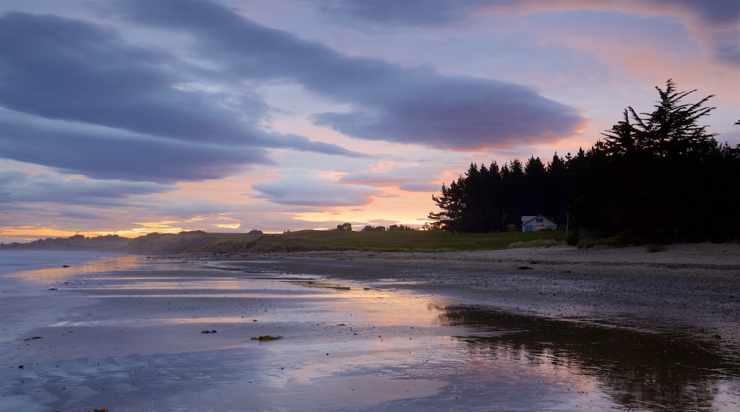 Oamaru featuring a beach, a bay or harbour and a sunset