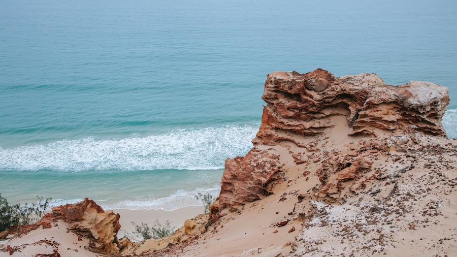 Rainbow Beach which includes general coastal views and rocky coastline