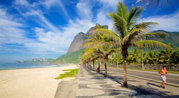 Avenida Atlântica caracterizando paisagens litorâneas, uma praia de areia e montanhas