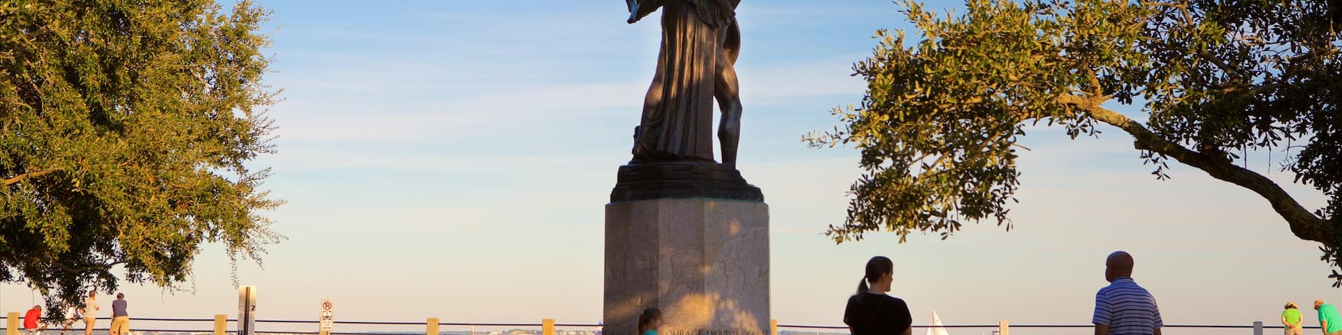 White Point Gardens which includes a statue or sculpture and general coastal views as well as a family