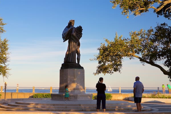 White Point Gardens which includes general coastal views and a statue or sculpture as well as a family