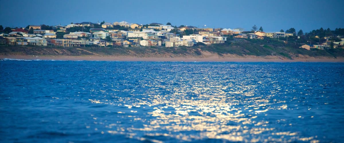 Victor Harbor showing waves, night scenes and a beach
