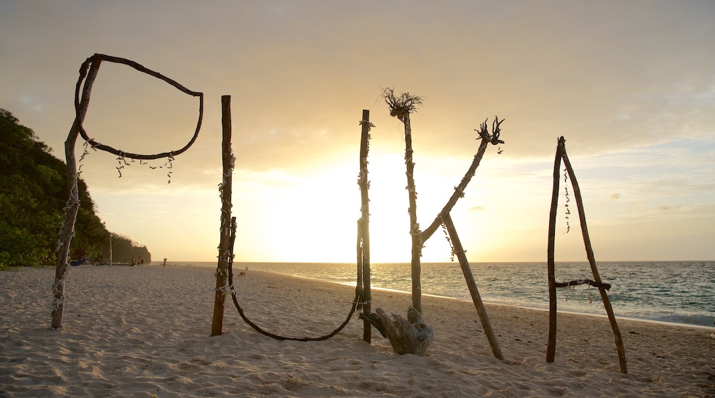 Puka Beach which includes a beach, tropical scenes and a sunset