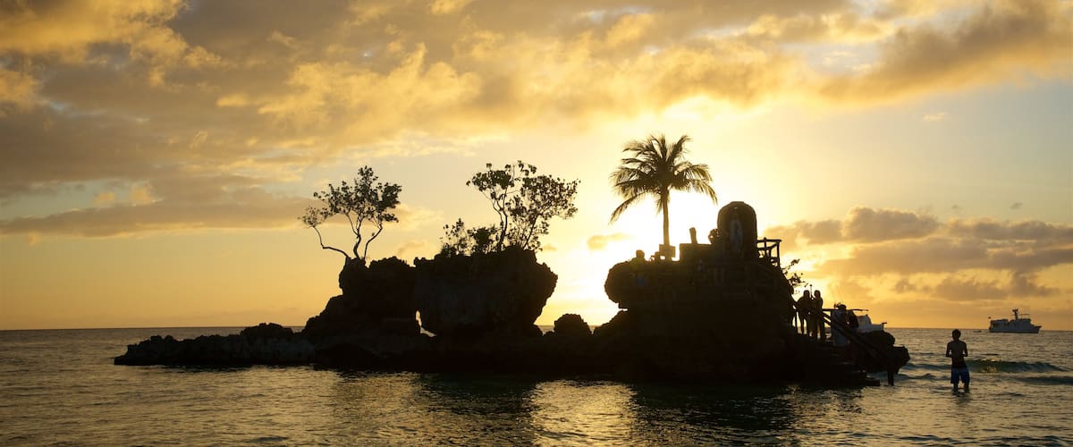 Willy\'s Rock featuring island images, tropical scenes and a sunset